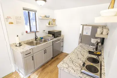a kitchen with a sink and a counter top at Fox Cabin - Lakefront - Sleeps 4 in Bass Lake