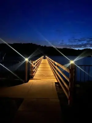 a bridge over a body of water at night at Fox Cabin - Lakefront - Sleeps 4 in Bass Lake