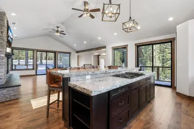 a kitchen with a large island with a counter top at Paradise on Pioneer - New 6 Bedroom w Pool Table in South Lake Tahoe