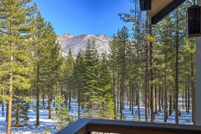 a view from the balcony of a house with trees and snow at Paradise on Pioneer - New 6 Bedroom w Pool Table in South Lake Tahoe