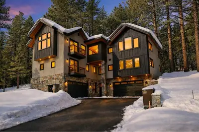 a house in the winter with snow on the ground at Paradise on Pioneer - New 6 Bedroom w Pool Table in South Lake Tahoe