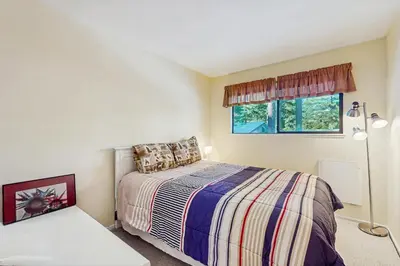a small bedroom with a bed and a window at Tahoe Summit Escape in Incline Village