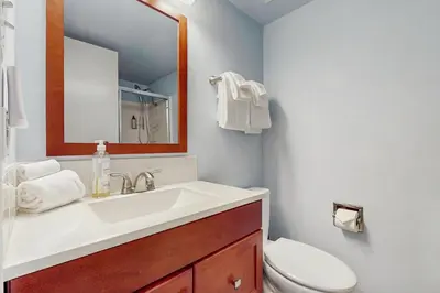 a bathroom with a sink and a toilet and a mirror at Tahoe Summit Escape in Incline Village