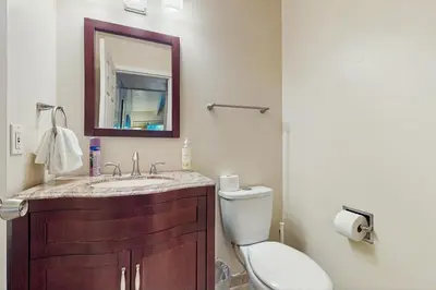 a bathroom with a toilet and a sink and a mirror at Tahoe Summit Escape in Incline Village