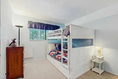 a bedroom with a white bunk bed and a window at Tahoe Summit Escape in Incline Village