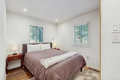 a bedroom with a bed and two windows at Aspen Pines Chalet in South Lake Tahoe