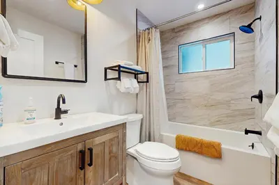 a bathroom with a sink and a toilet and a tub at Aspen Pines Chalet in South Lake Tahoe