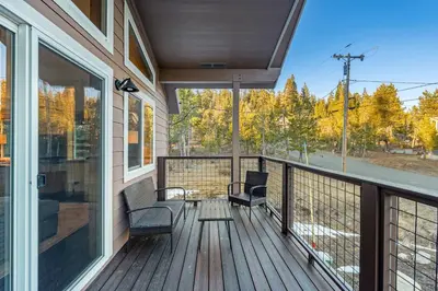 a porch with two chairs and a balcony with trees at Mountain Retreat - Sleeps 7 - Canoe - Fireplace in Soda Springs
