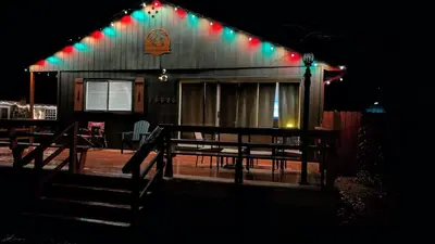 a house with christmas lights on the side of it at Sierra Cabin w NEW Hot Tub Walk to Town in Twain Harte
