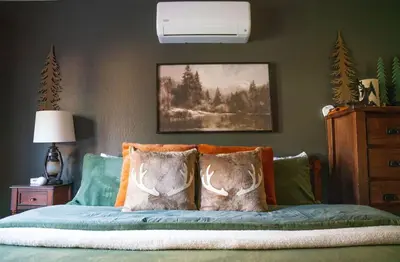 a bedroom with a bed with two pillows on it at Sierra Cabin w NEW Hot Tub Walk to Town in Twain Harte