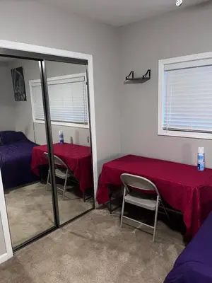 a room with two tables and a mirror at 35th Avenue room for rent in Sacramento