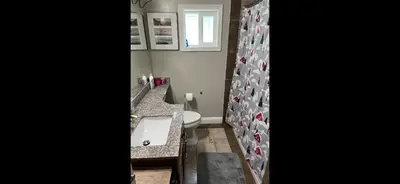 a bathroom with a sink and a toilet and a mirror at 35th Avenue room for rent in Sacramento