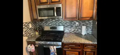 a kitchen with a stove and a microwave at 35th Avenue room for rent in Sacramento