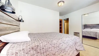 a bedroom with a bed and a mirror at Timberline #08 condo in Mammoth Lakes