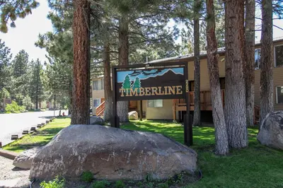 a sign in front of a building with trees at Timberline #08 condo in Mammoth Lakes