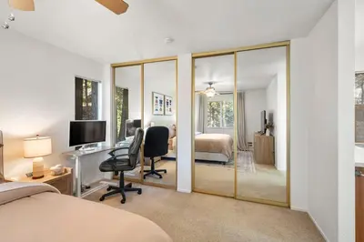 a bedroom with a bed and a desk with a computer at Modern Cabin Escape wGame Room, Huge Deck, WIFI in Arnold