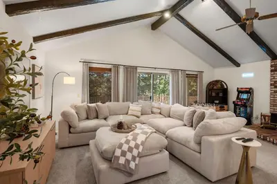 a living room with a white couch and a table at Modern Cabin Escape wGame Room, Huge Deck, WIFI in Arnold