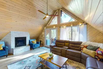 a living room with a couch and a fireplace at Yosemite Escape in White Wolf