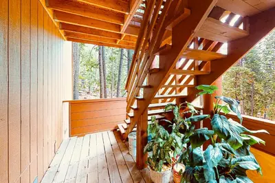 a wooden staircase in a house with a plant at Yosemite Escape in White Wolf