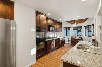 a kitchen with a stainless steel refrigerator and wooden cabinets at Yosemite Spirit in White Wolf