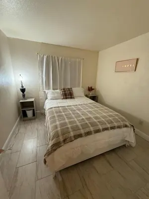 a bedroom with a large bed and a window at Vineyard inspired house in stockton in Stockton