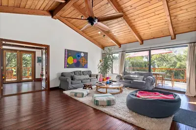 a living room with a couch and a table at Cozy Lake View 4Bd 2,5Br Retreat in 5 Acres, Hot Tub and more in Auburn