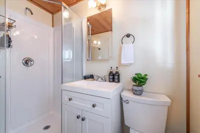 a bathroom with a toilet and a sink and a shower at Midiron Golf Cabin cabin in Tahoe Vista