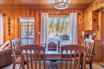 a dining room with a table and chairs and a window at Midiron Golf Cabin cabin in Tahoe Vista