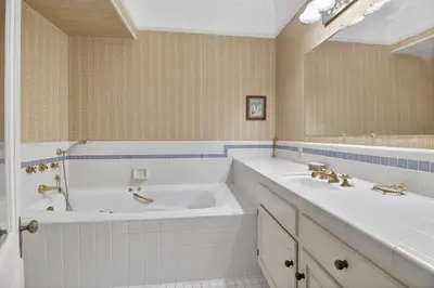 a bathroom with two sinks and a tub and a mirror at The Spalding House Comfort in Visalia home in Visalia