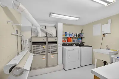 a kitchen with white appliances and a sink at The Spalding House Comfort in Visalia home in Visalia
