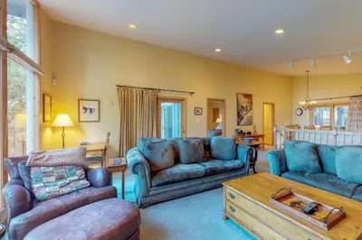 a living room with blue couches and a table at Lakeview Luxury Getaway in South Lake Tahoe
