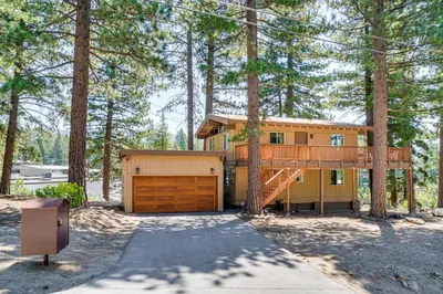 a house in the woods with a garage at Walk to Lake Tahoe Family Retreat with Deck! in Incline Village