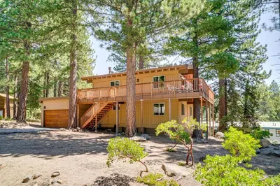 a house in the woods with a deck at Walk to Lake Tahoe Family Retreat with Deck! in Incline Village