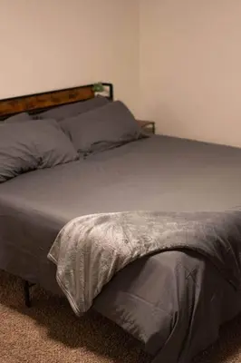 a bed with a wooden headboard in a bedroom at Kipps Hill Haven B — Folsom Lake Escape in El Dorado Hills