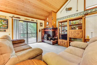 a living room with couches and a fireplace at Community Perks and Watercrafts Shaver Lake Condo in Shaver Lake
