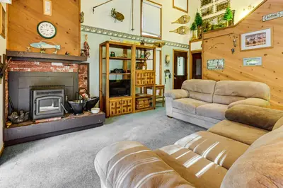 a living room with a couch and a fireplace at Community Perks and Watercrafts Shaver Lake Condo in Shaver Lake