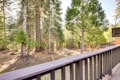 a wooden deck with a view of a forest at Community Perks and Watercrafts Shaver Lake Condo in Shaver Lake