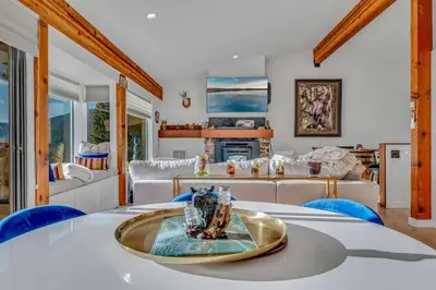a living room with a table and a couch at Incline Village Views - Pellet Stove Deck in Incline Village