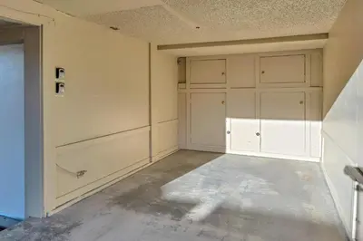 an empty garage with white cabinets and a concrete floor at Incline Village Views - Pellet Stove Deck in Incline Village