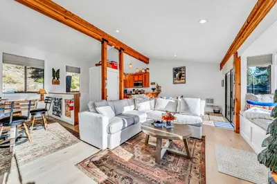 a living room with white furniture and a table at Incline Village Views - Pellet Stove Deck in Incline Village