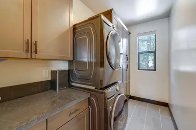 a kitchen with a stainless steel refrigerator and cabinets at Steps From Sledding Hill! Soda Springs Mtn Retreat in Soda Springs