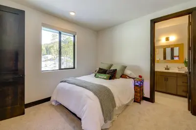 a bedroom with a bed and a sink and a mirror at Steps From Sledding Hill! Soda Springs Mtn Retreat in Soda Springs