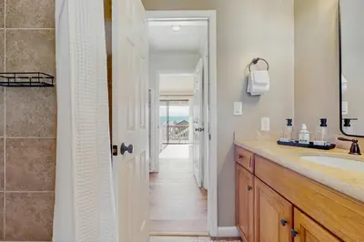 a bathroom with a sink and a mirror and a hallway at Spectacular Lake Views in Tahoe City