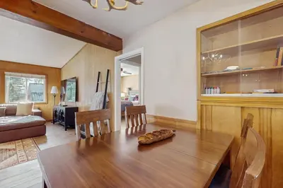 a dining room with a table and a living room at Lakeside Ski House in Carnelian Bay