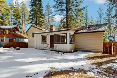 a small house in the snow with a fence at Lakeside Ski House in Carnelian Bay