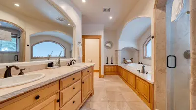 a bathroom with two sinks and a tub and a shower at 2 Truckee Cabin • Sleeps 20 • Hot tub • Games • Near Donner Lake Donner Ridge Alplenglow Chalet by AvantStay in Truckee