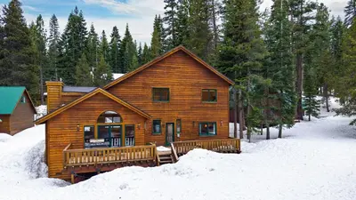 a log cabin in the snow in the woods at 2 Truckee Cabin • Sleeps 20 • Hot tub • Games • Near Donner Lake Donner Ridge Alplenglow Chalet by AvantStay in Truckee