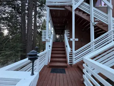 a stairway leading to a house with white rails at El Capitan Hideaway - A-Frame Cabin Yosemite West in Yosemite West