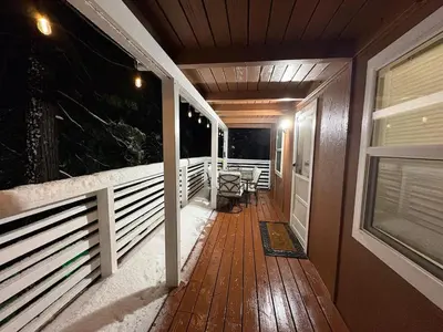 a front porch of a house with a wooden deck at Half Dome Haven - Cozy Yosemite West Studio in Yosemite West