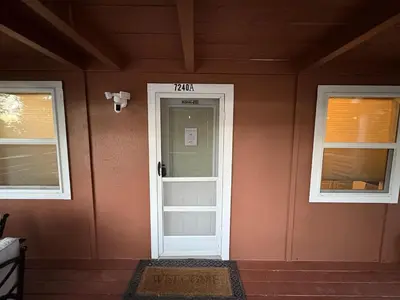 a house with a white door and two windows at Half Dome Haven - Cozy Yosemite West Studio in Yosemite West